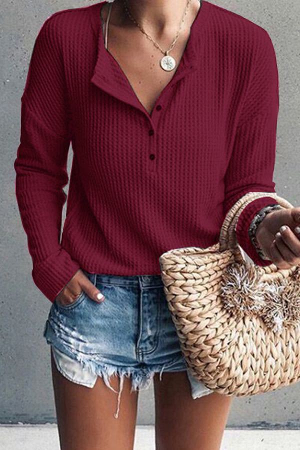 Buttoned blouse with V-neck and long sleeves