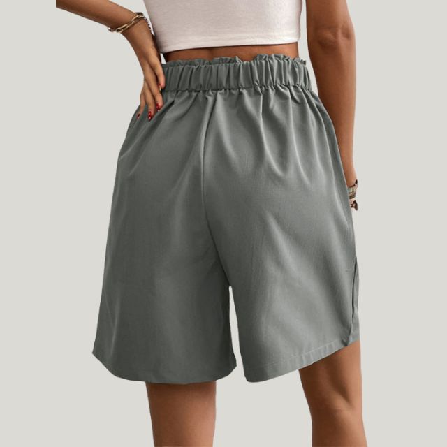 Pleated A-line skirt with button detail