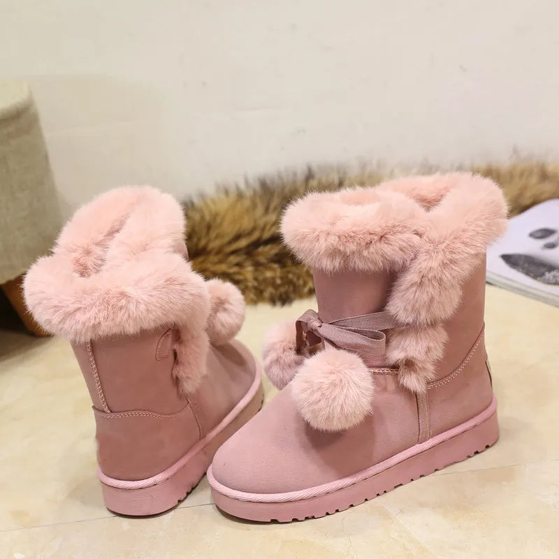 Elegant winter boots with pompom embellishment