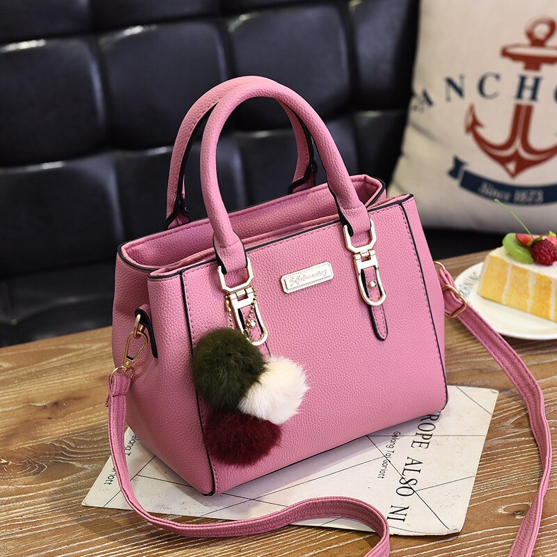 Leather handbag with 3 soft plush balls