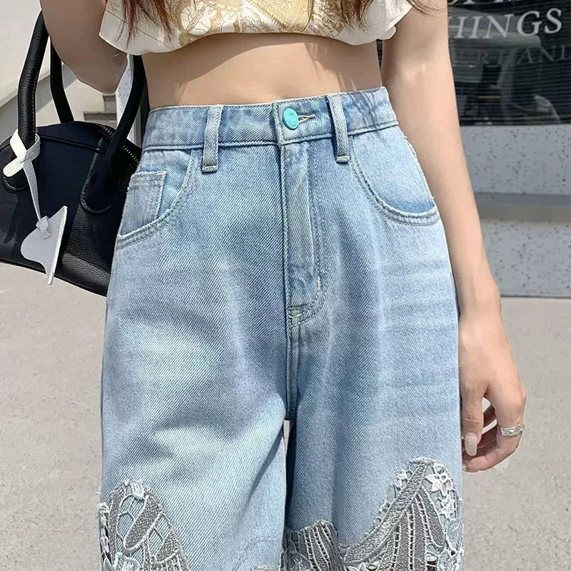 High-waisted denim trousers with lace details