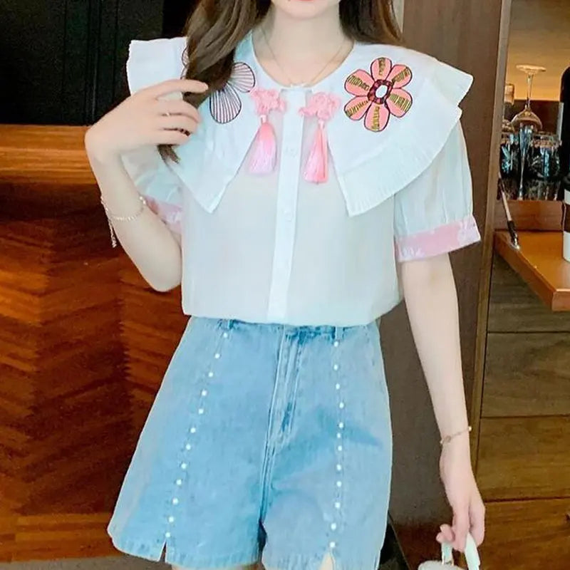 Fashionable summer blouse with embroidery and short sleeves