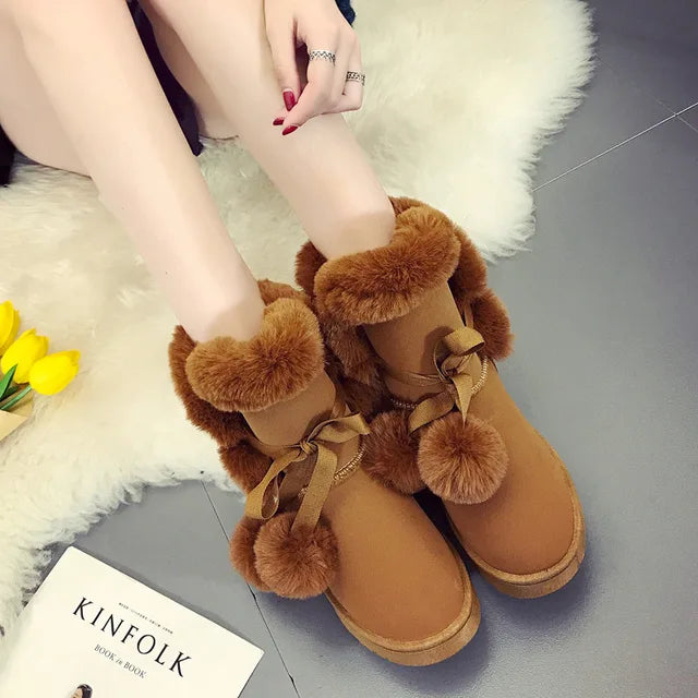 Elegant winter boots with pompom embellishment