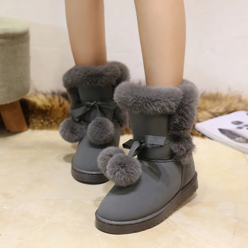 Elegant winter boots with pompom embellishment