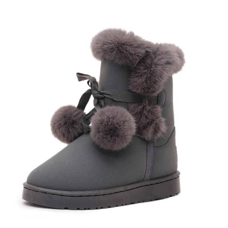 Elegant winter boots with pompom embellishment